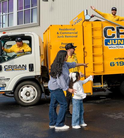 Family watching the Crisan crew clear out a storage unit