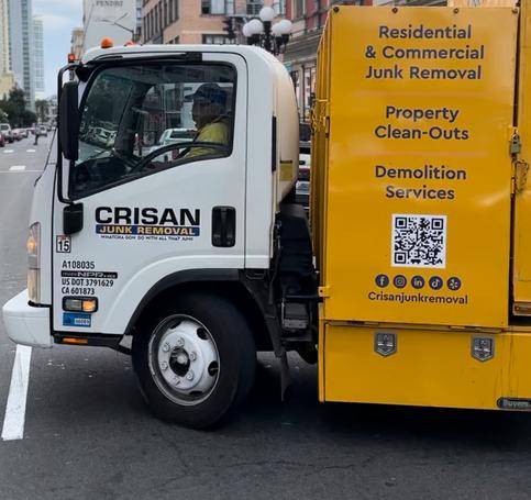 Crisan Junk Removal truck driving through downtown San Diego